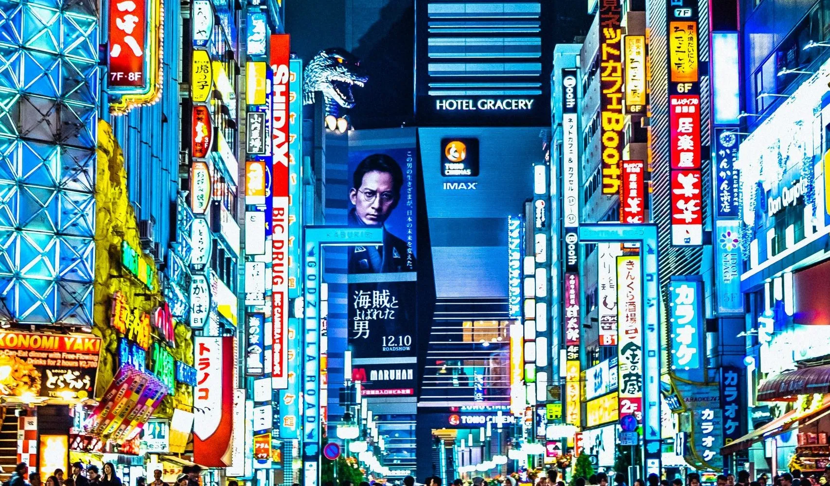 A crowded Tokyo street at night lit by neon signs