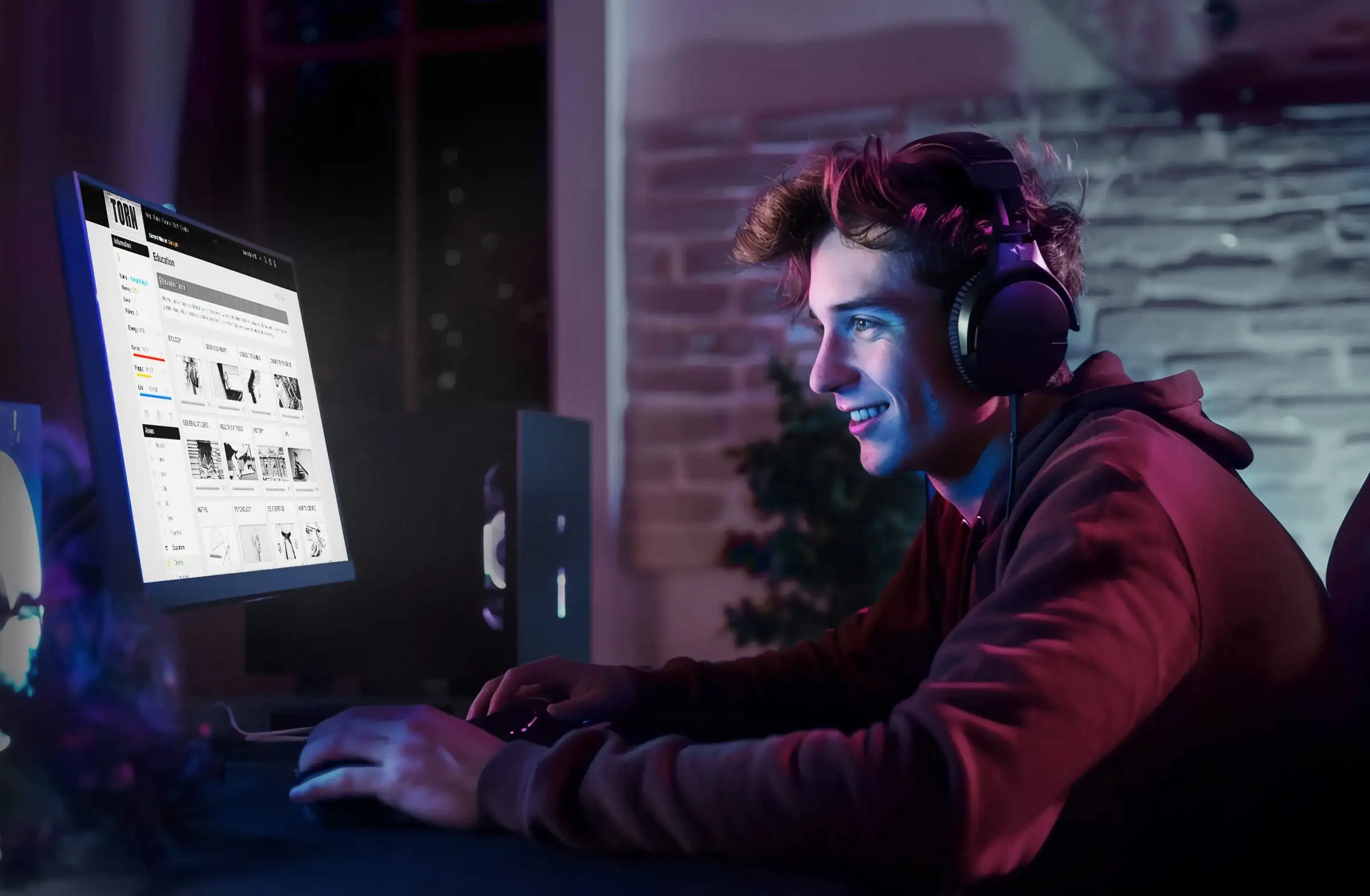 A player at a desk wearing headphones, playing Torn on a monitor